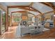 Bright, open living room with hardwood floors, wood beams, stone fireplace, and bar area at 1420 Sierra Dr, Boulder, CO 80302