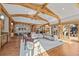 Living room featuring an open floor plan, wood beams, and access to the dining room and waterfall view at 1420 Sierra Dr, Boulder, CO 80302