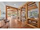 Open concept with wooden beams, hardwood floors, dining area, living room, and stone fireplace at 1420 Sierra Dr, Boulder, CO 80302
