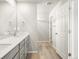 Bathroom featuring a double vanity and doorway to walk-in closet at 765 N Tibet St, Aurora, CO 80018
