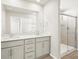 Bathroom featuring double vanity with stone countertop and glass shower at 765 N Tibet St, Aurora, CO 80018