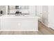Spacious island with sink, faucet, quartz countertop, and light gray cabinets in the kitchen at 765 N Tibet St, Aurora, CO 80018