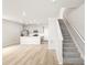 Bright living room and kitchen boast open floor plan, recessed lighting, and staircase at 765 N Tibet St, Aurora, CO 80018