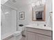Clean bathroom featuring glass enclosed shower, toilet, vanity with sink and modern fixtures at 2533 N Emerson St, Denver, CO 80205