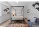 Cozy bedroom featuring a four-poster bed, stylish decor, and comfortable seating area at 2533 N Emerson St, Denver, CO 80205