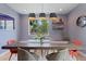 Well-lit dining room featuring a rustic wooden table, pendant lighting, and a modern aesthetic at 2533 N Emerson St, Denver, CO 80205
