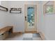 Inviting entryway with wooden bench, storage shelves, and view of the home's backyard at 2533 N Emerson St, Denver, CO 80205