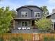 Charming two-story home with a beautifully landscaped front yard and inviting covered porch at 2533 N Emerson St, Denver, CO 80205