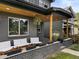 Inviting front porch with comfortable seating, hanging plants, and stylish brick accents at 2533 N Emerson St, Denver, CO 80205