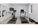Home gym with state-of-the-art equipment, mirrored wall, and a bright, airy atmosphere at 2533 N Emerson St, Denver, CO 80205