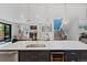 Modern kitchen boasts a large island, stainless steel appliances, and pendant lighting at 2533 N Emerson St, Denver, CO 80205