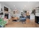 Open-concept living room flowing into kitchen with fireplace, stylish decor, and hardwood floors at 2533 N Emerson St, Denver, CO 80205
