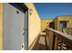 Exterior of the unit featuring an exterior walkway, wood railing, and building exterior under a bright blue sky at 2711 Mapleton Ave # 27, Boulder, CO 80304