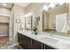 Bathroom features a double vanity with modern fixtures and a luxurious bathtub at 5438 Valentia St, Denver, CO 80238