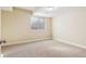 Vacant bedroom featuring neutral carpet, neutral paint, white trim, and one window at 5438 Valentia St, Denver, CO 80238