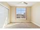 Bedroom featuring carpeted flooring, a ceiling fan, and a window overlooking a rooftop at 5438 Valentia St, Denver, CO 80238