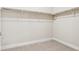 Walk-in closet featuring neutral carpet, white paint, and an upper shelf with a metal bar at 5438 Valentia St, Denver, CO 80238