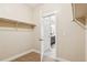 Walk-in closet with carpeted flooring, shelf and rod, with bathroom access at 5438 Valentia St, Denver, CO 80238