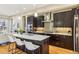 A modern kitchen island is complete with white counter top and stainless steal appliances at 5438 Valentia St, Denver, CO 80238