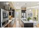 A modern kitchen island and stainless steel appliances at 5438 Valentia St, Denver, CO 80238