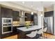 Modern kitchen island with stainless steel fridge and white counter tops at 5438 Valentia St, Denver, CO 80238