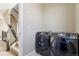 Bright laundry room featuring new front-load washer and dryer units at 5438 Valentia St, Denver, CO 80238