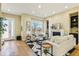 Bright living room with large window, fireplace, hardwood floors, and neutral decor at 5438 Valentia St, Denver, CO 80238