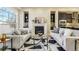 Cozy living room featuring a fireplace, built-in shelving, and neutral decor at 5438 Valentia St, Denver, CO 80238