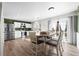 Open kitchen and dining area with white cabinets, stainless appliances, and lots of light at 1424 Swan Ave, Brighton, CO 80601