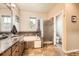 Another angle of the full bathroom featuring a large soaking tub and tiled shower at 11839 E Maplewood Ave, Greenwood Village, CO 80111