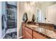 Stylish bathroom with granite countertop vanity and tiled shower with glass door at 11839 E Maplewood Ave, Greenwood Village, CO 80111