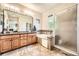 Full bathroom featuring a large soaking tub, vanity and tiled shower at 11839 E Maplewood Ave, Greenwood Village, CO 80111