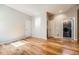 Open bedroom leading to a laundry room; Hardwood flooring expands the area, creating a bright space at 11839 E Maplewood Ave, Greenwood Village, CO 80111