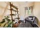 Cozy bedroom nook with a decorative ladder bookshelf, chair and natural light at 11839 E Maplewood Ave, Greenwood Village, CO 80111