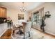 Bright dining room with hardwood floors, chandelier lighting, and many live plants throughout at 11839 E Maplewood Ave, Greenwood Village, CO 80111