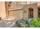 Inviting tan home with a beige two-car garage, arched entry, and a tidy landscaped front yard at 11839 E Maplewood Ave, Greenwood Village, CO 80111