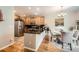 Well-lit kitchen with stainless steel appliances, dark countertops, and a dining area nearby at 11839 E Maplewood Ave, Greenwood Village, CO 80111
