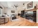 Stylish living room with hardwood floors, a fireplace, and a comfortable seating arrangement at 11839 E Maplewood Ave, Greenwood Village, CO 80111