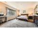 Comfortable main bedroom with a large window for natural light and neutral decor at 11839 E Maplewood Ave, Greenwood Village, CO 80111