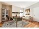 Office with a desk, sofa, shelving, and artwork creating an ideal and inspiring workspace at 11839 E Maplewood Ave, Greenwood Village, CO 80111