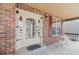 Brick facade with ornate white door and small porch at 154 Cisne Cir, Brighton, CO 80601