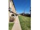 Building exterior showcasing a grassy area and walkway at 234 S Brentwood St # 105, Lakewood, CO 80226