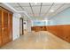 Spacious basement with a bar area, wood paneling, and ample storage space at 1803 Graves Ct, Northglenn, CO 80233