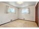 Bedroom with neutral carpet, white walls, and two windows providing ample natural light at 1803 Graves Ct, Northglenn, CO 80233