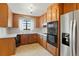 Efficient kitchen with ample wood cabinetry, stainless steel appliances, and bright white countertops at 1803 Graves Ct, Northglenn, CO 80233