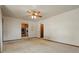 Open living room with a ceiling fan, hardwood trim, and access to the kitchen at 1803 Graves Ct, Northglenn, CO 80233