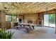Enclosed patio features a brick fireplace, seating, and sliding door access to the backyard at 1803 Graves Ct, Northglenn, CO 80233