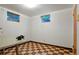 Versatile room with checkered flooring, natural light and workshop space at 1803 Graves Ct, Northglenn, CO 80233