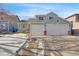 Two-story house with a gray exterior, two-car garage, and a partially snow-covered front yard at 8937 Apache Plume Dr, Parker, CO 80134