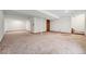 Spacious unfinished basement featuring neutral carpet, support beams, and access to stairs at 10208 E Jewell Ave # 18, Aurora, CO 80247
